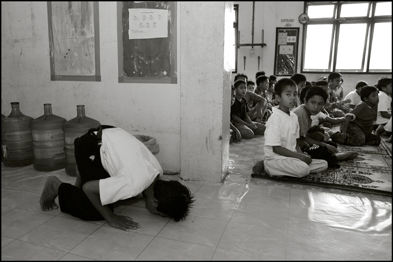 A boy does his prayer in the hall at an orphanage in Banda Aceh Indonesia