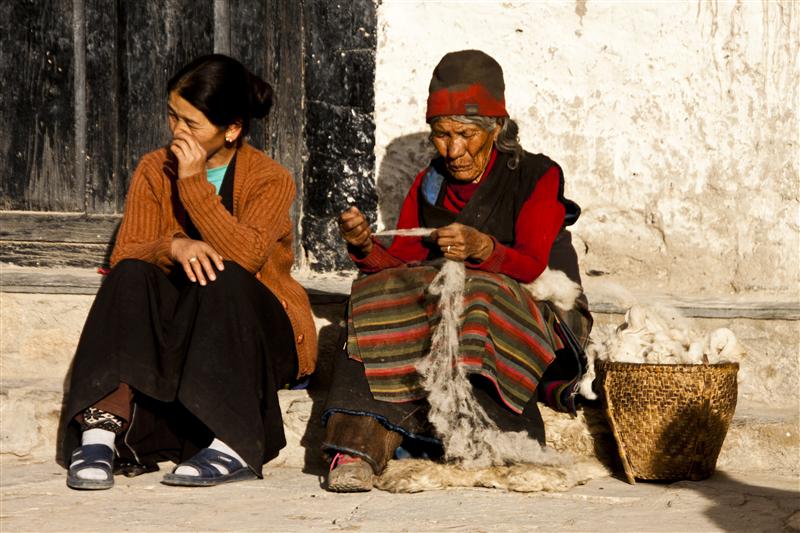 Local separate themselves with almost no connectivity for six months a year. In picture are Loba women that perform local duties, one of which is working with wool.