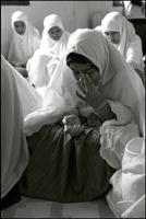 A girl wipes away her tears after they prayed fot the tsunami victims at an orphanage in Banda Aceh Indonesia